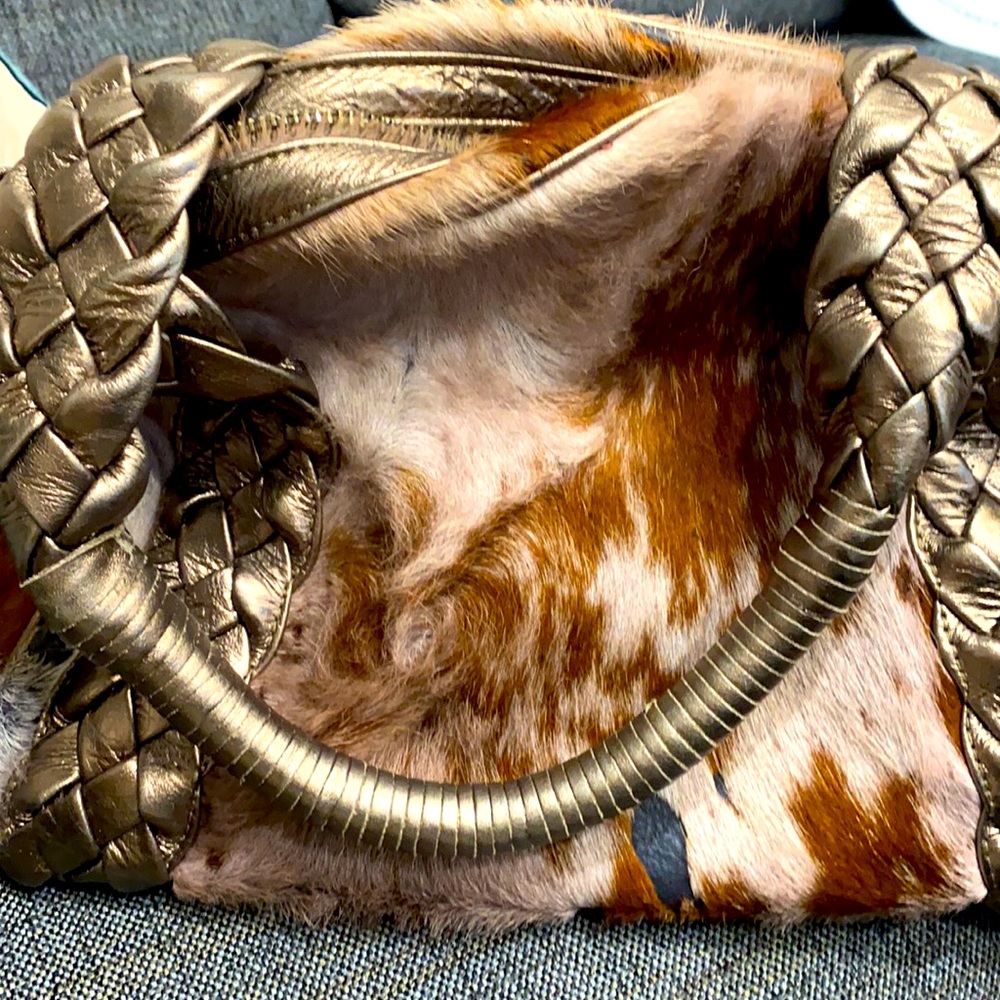 Real fur mid size distressed purse.